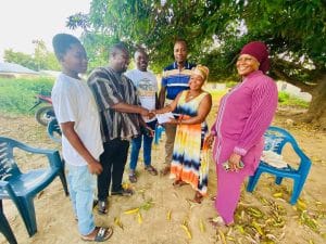 mother of Master Tangom Maxwell Receiving the donation on behalf of her son